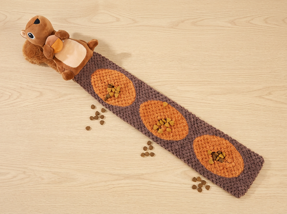  Long brown snuffle mat with three orange treat-hiding sections attached to a plush squirrel dog toy