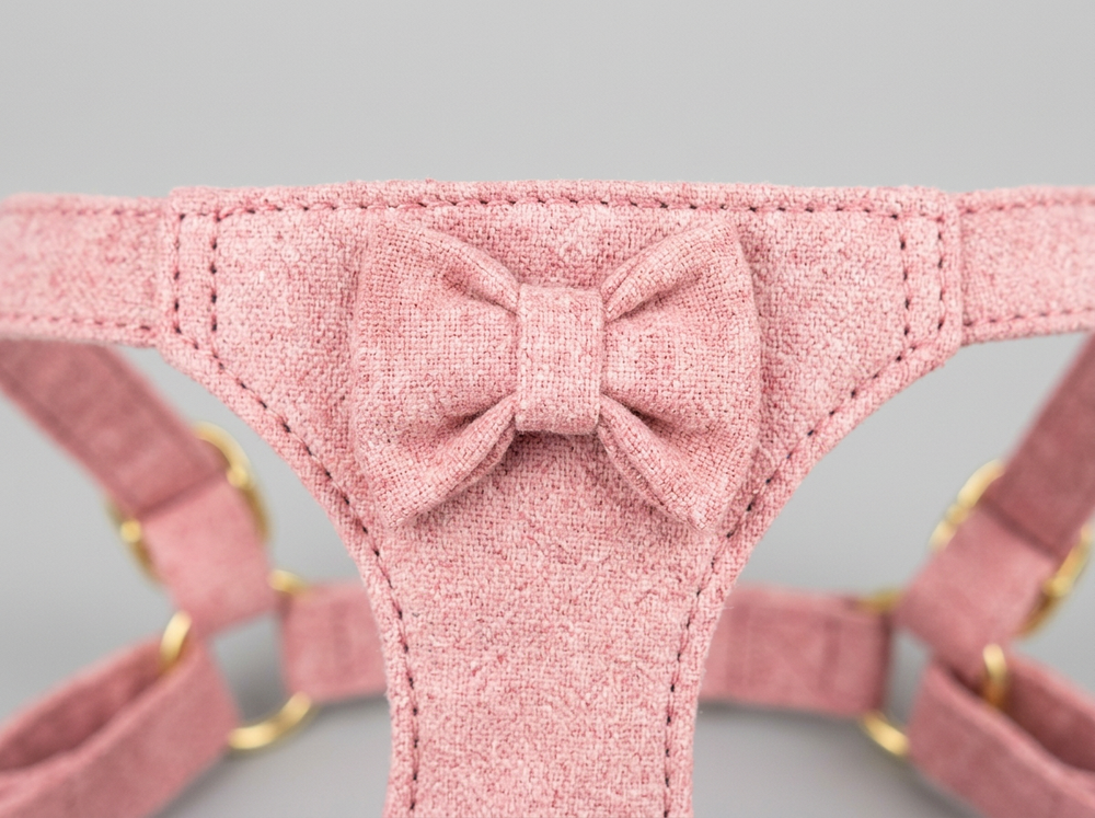 Decorative matching bow on a mustard yellow puppy walking harness